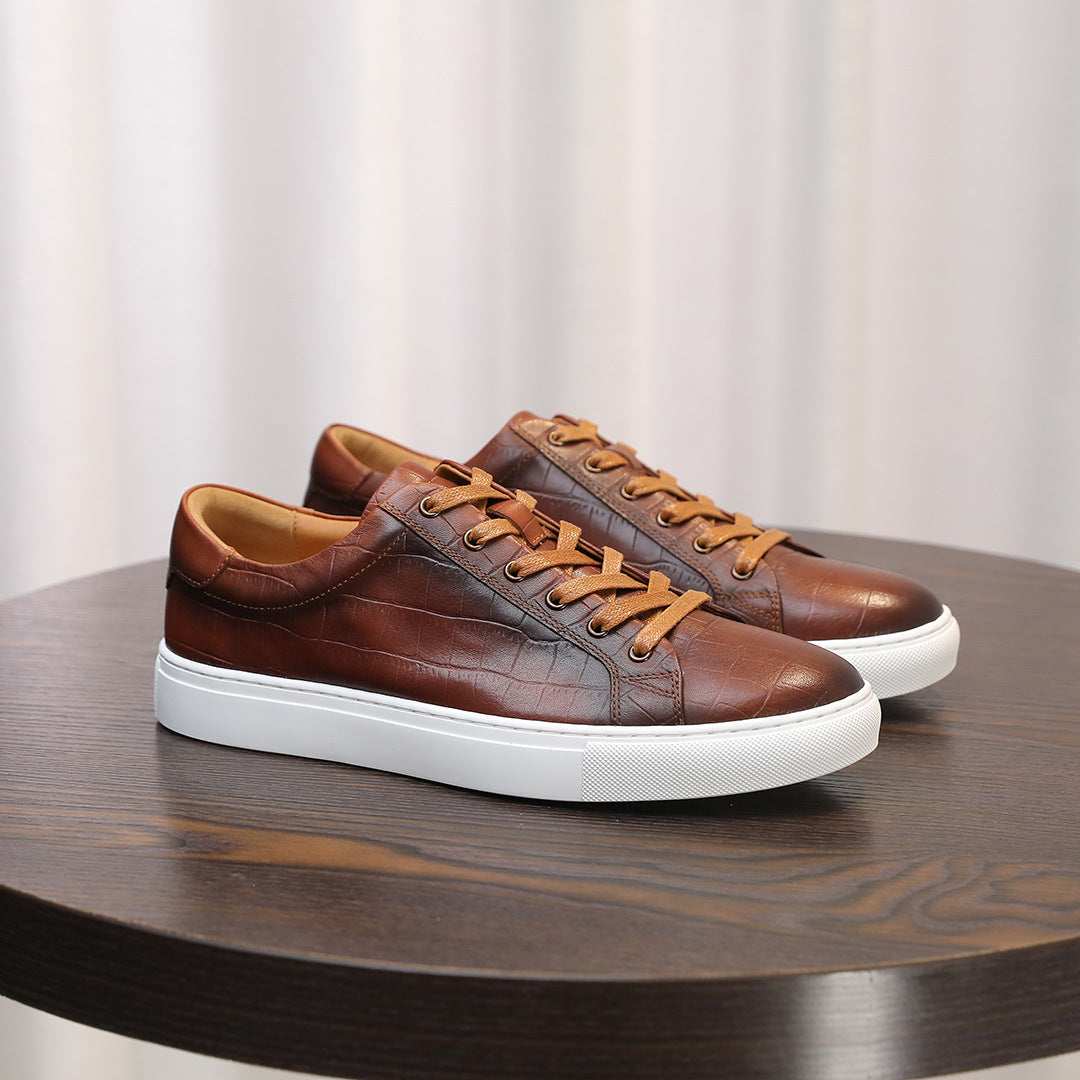 Men's brown genuine leather sneakers, side view with textured leather and white sole.