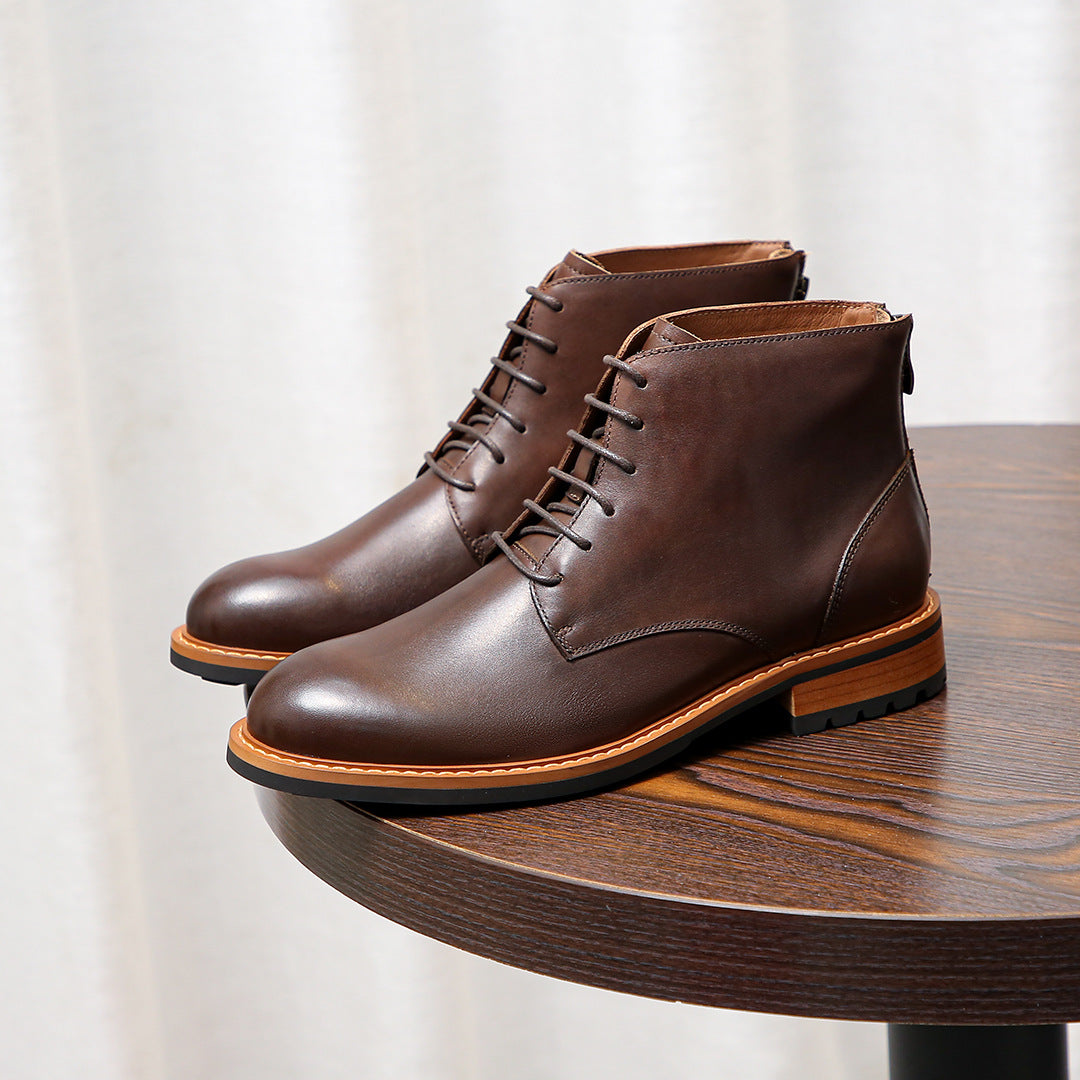 Dark brown leather pointed-toe lace-up ankle boots with tan edge trim and stitched panels