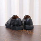 Men's black leather sneakers back view with cushioned heel and rubber sole