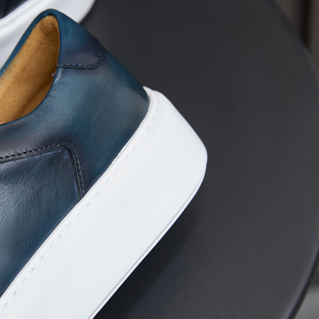 Navy leather sneaker upper with collar seam details and white platform sole