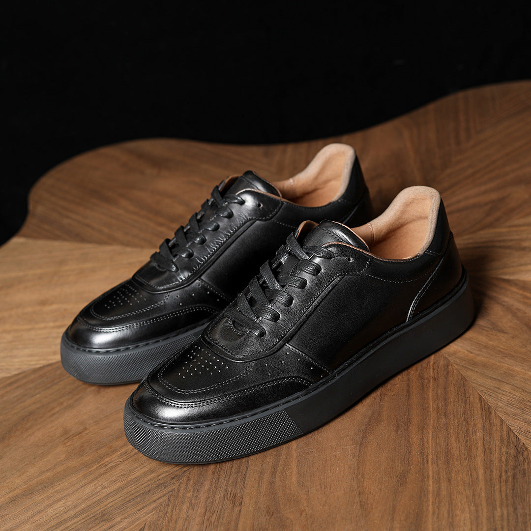 Black genuine leather sneakers, angled view with lace-up front and chunky dark sole