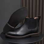 Men's pointed-toe Chelsea dress boots, black leather upper with elastic side gores