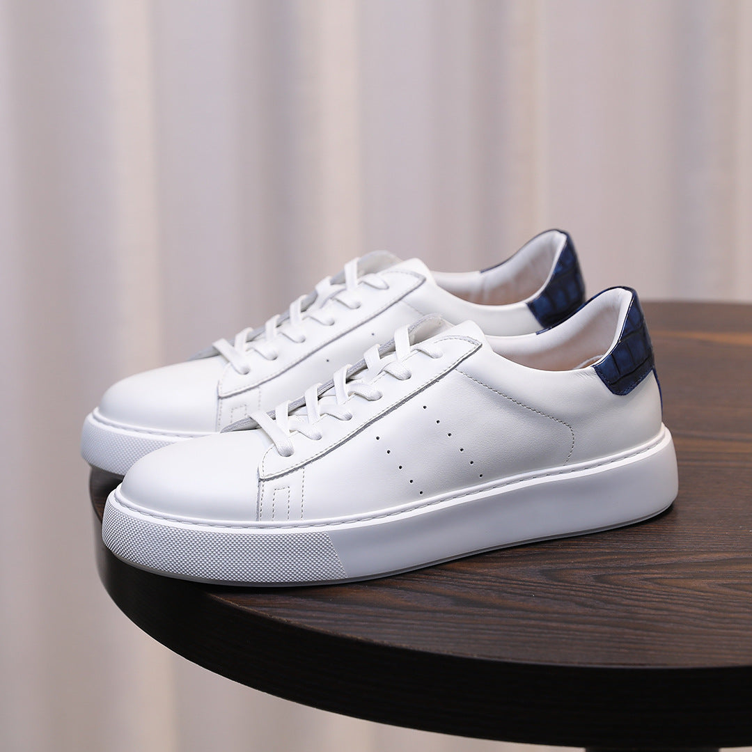 Men's white leather low-top sneakers with lace-up, blue heel accents, and white sole