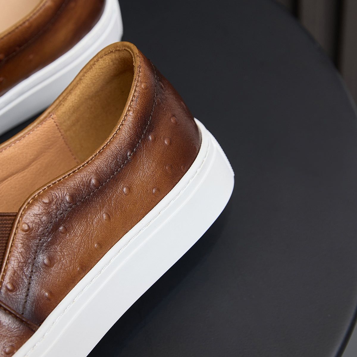 Close-up of brown leather sneaker side and collar with white platform sole