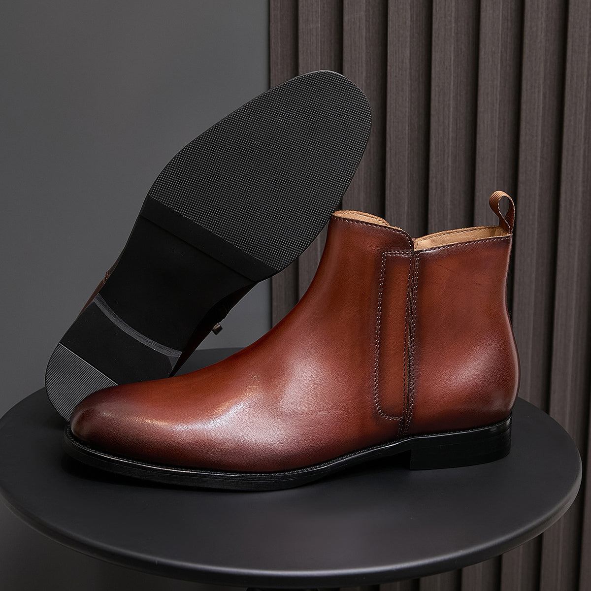 Men's pointed-toe leather dress boot with side zip, brown leather and black sole.