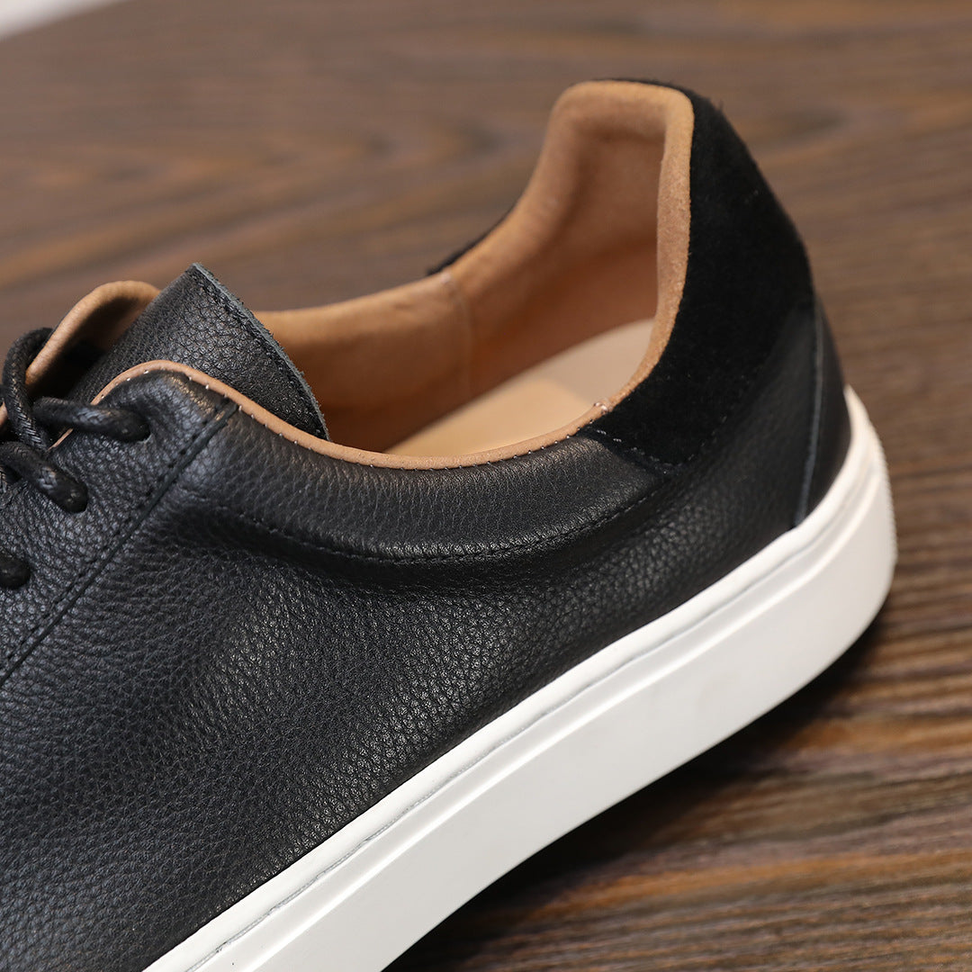 Men's black leather sneaker with padded collar, tan lining, and white platform sole.