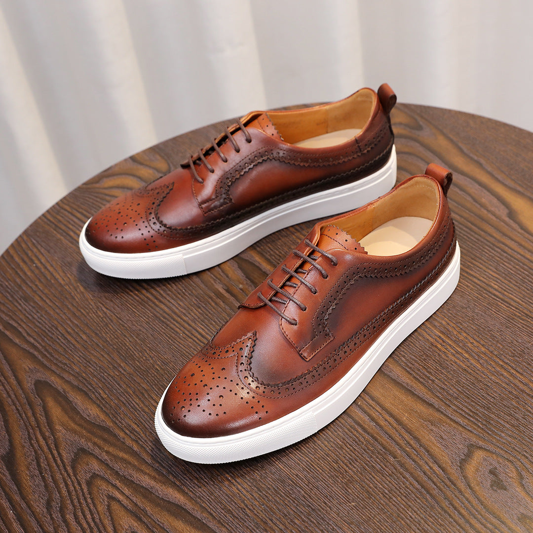 Pair of brown leather sneakers with laces and white soles on display