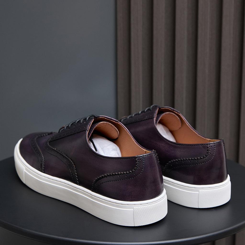 Pair of dark purple leather sneakers with lace-up front and white sole heel view