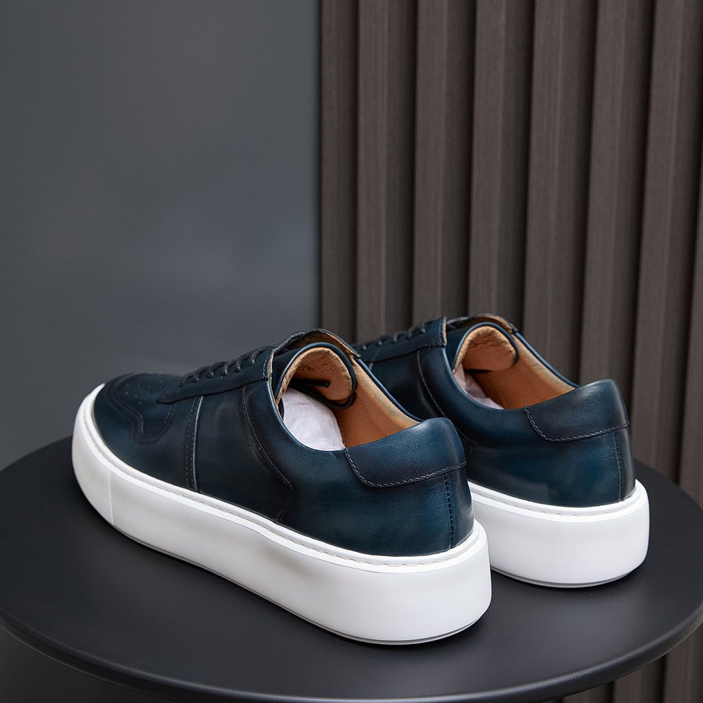 Men's navy leather sneakers with cushioned heel back and white platform sole
