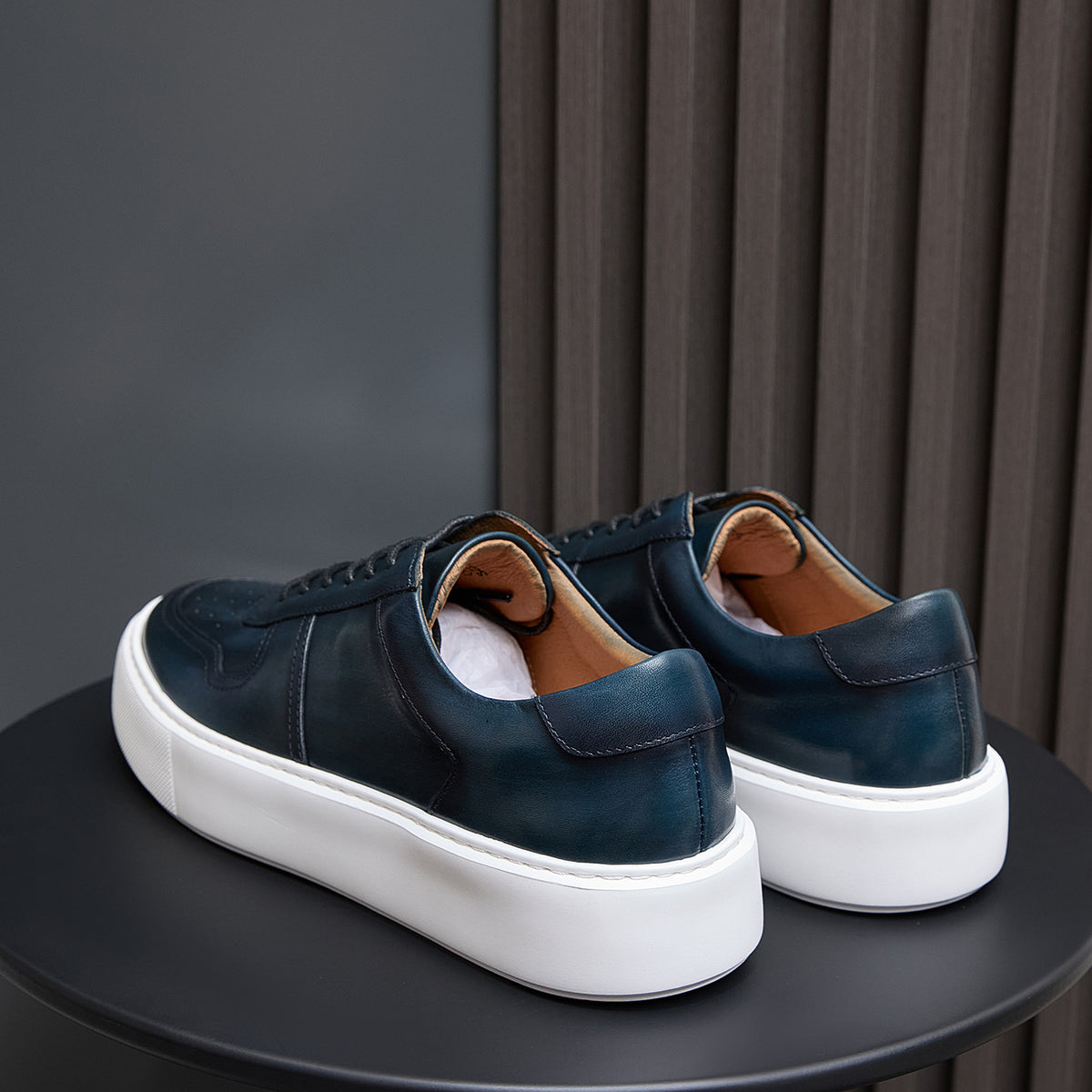 Men's navy leather sneakers with cushioned heel back and white platform sole