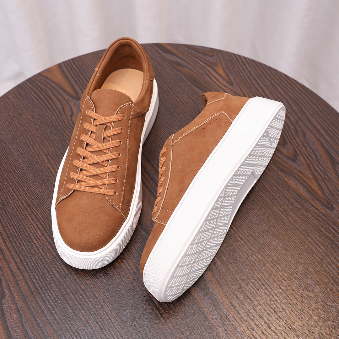 Men's brown leather sneakers with orange laces, white sidewall, and low profile