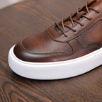 Men's brown leather sneaker toe with lace-up and white rubber sole