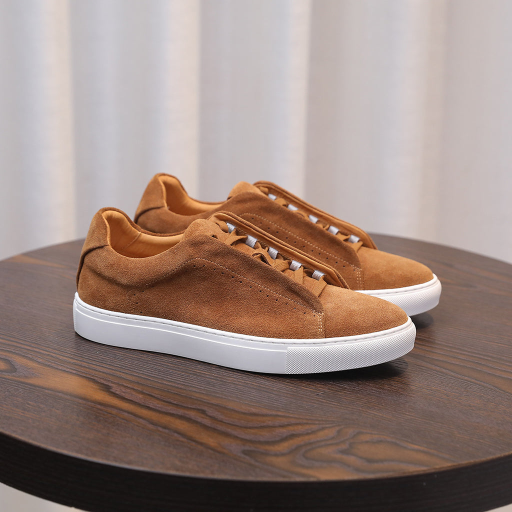 Men's tan/brown suede leather sneakers, lace-up with white sole, side angle.