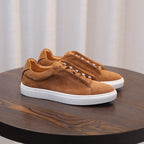 Men's tan/brown suede leather sneakers, lace-up with white sole, side angle.