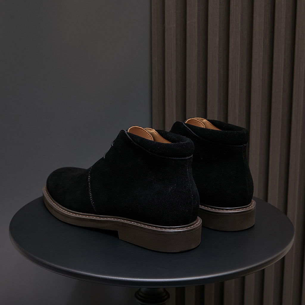 Pair of men's black lace-up chukka boots with plain toe and contrast sole trim
