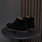 Pair of men's black lace-up chukka boots with plain toe and contrast sole trim