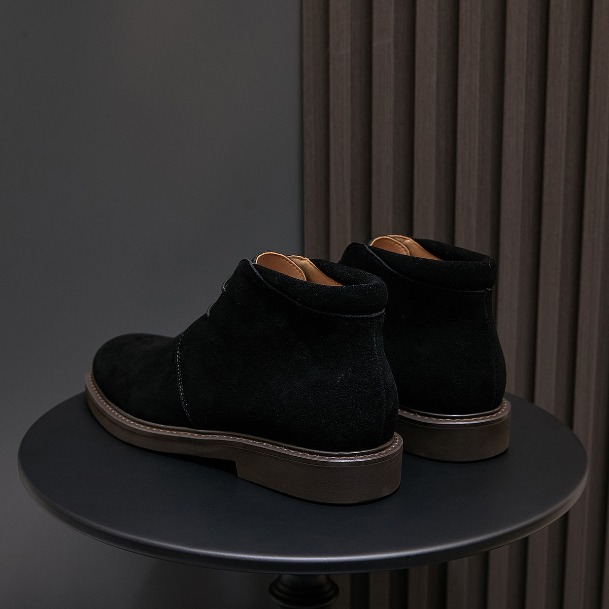 Pair of men's black lace-up chukka boots with plain toe and contrast sole trim