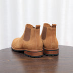 Pair of men's suede chelsea dress boots in tan/brown with stacked heel and side elastic