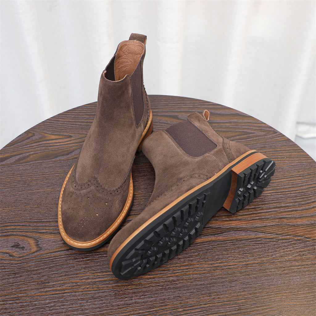 Dark brown suede chelsea boots with pointed toe and textured tread sole