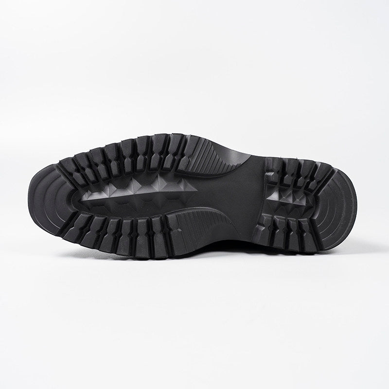 Black rubber boot outsole with deep tread pattern for traction