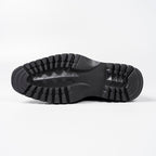 Black rubber boot outsole with deep tread pattern for traction