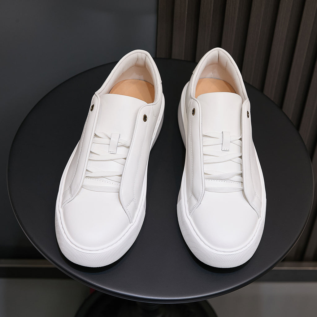 White leather low-top sneakers with lace-up front and white rubber sole