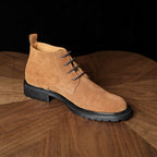 Men's tan suede chukka boot with lace-up front and textured rubber sole