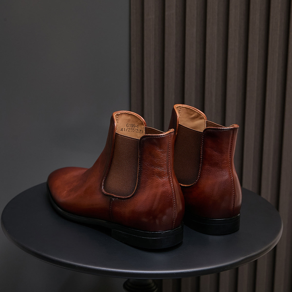 Brown pointed-toe Chelsea dress boots with elastic side panels and low stacked heel