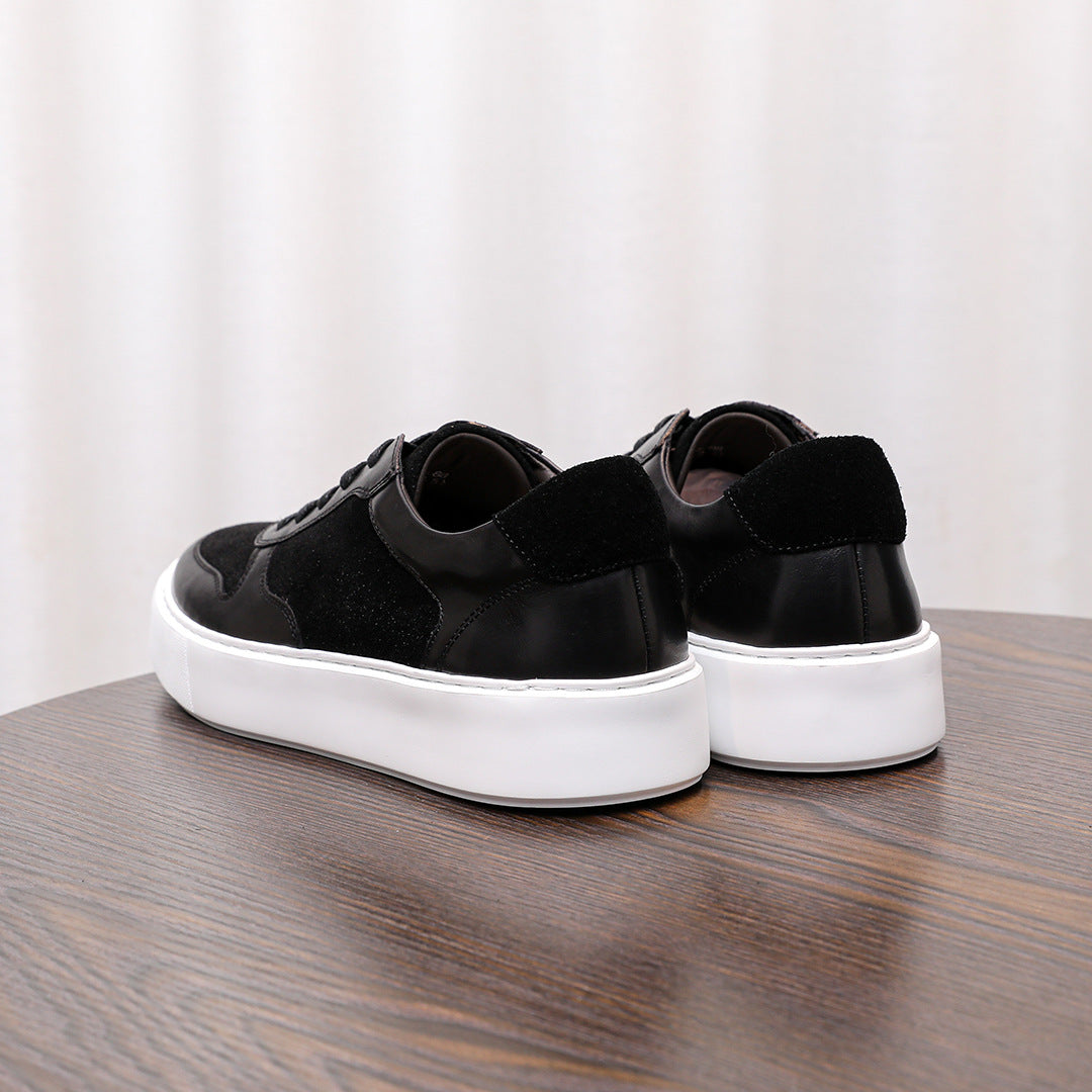 Black leather low-top sneakers, heel view with white rubber sole and lace ties