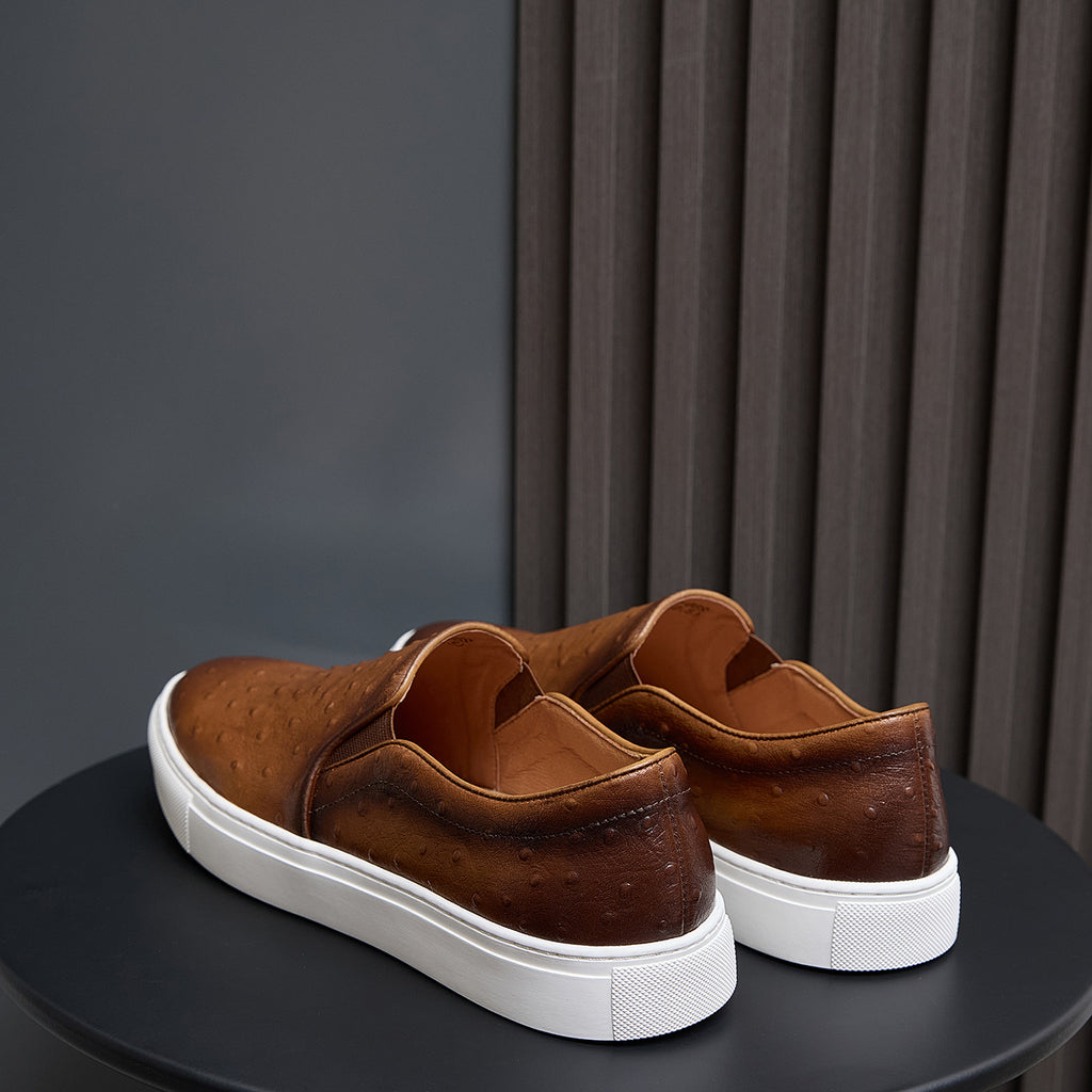 Brown leather slip-on sneakers rear view with padded heel and white rubber sole