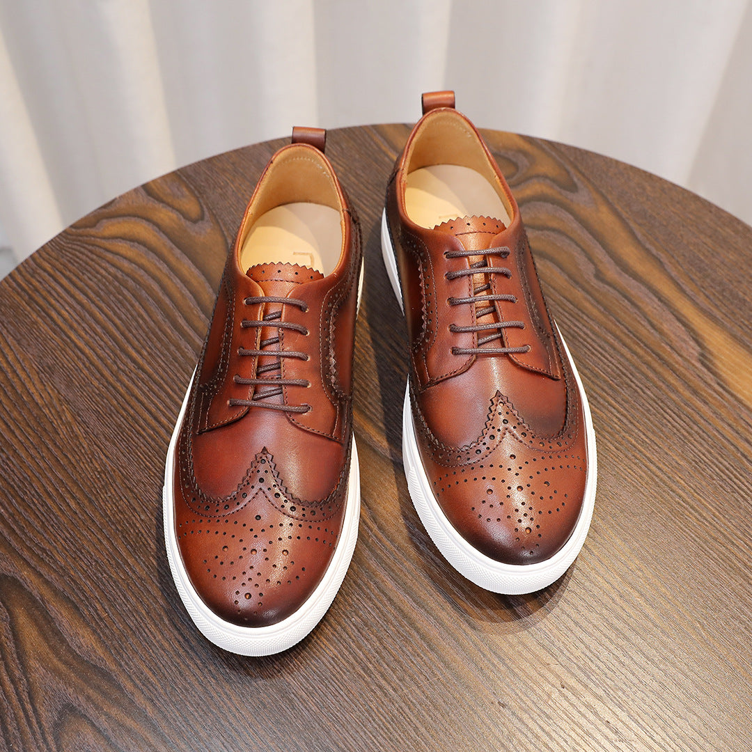 Brown leather lace-up sneakers, wingtip perforations, tongue lining visible