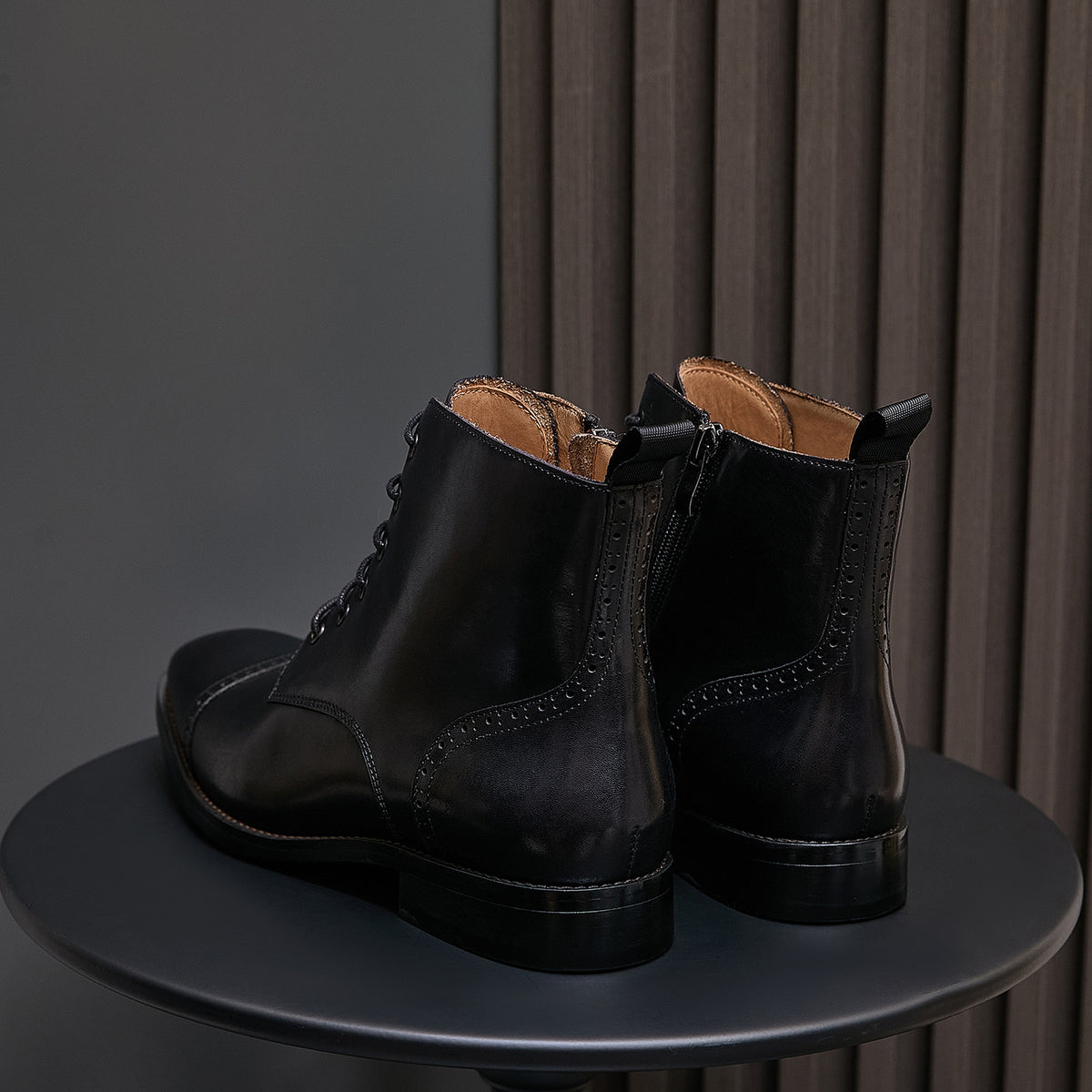 Black pointed-toe leather side-zip dress boots, lace-up front, leather-lined interior visible