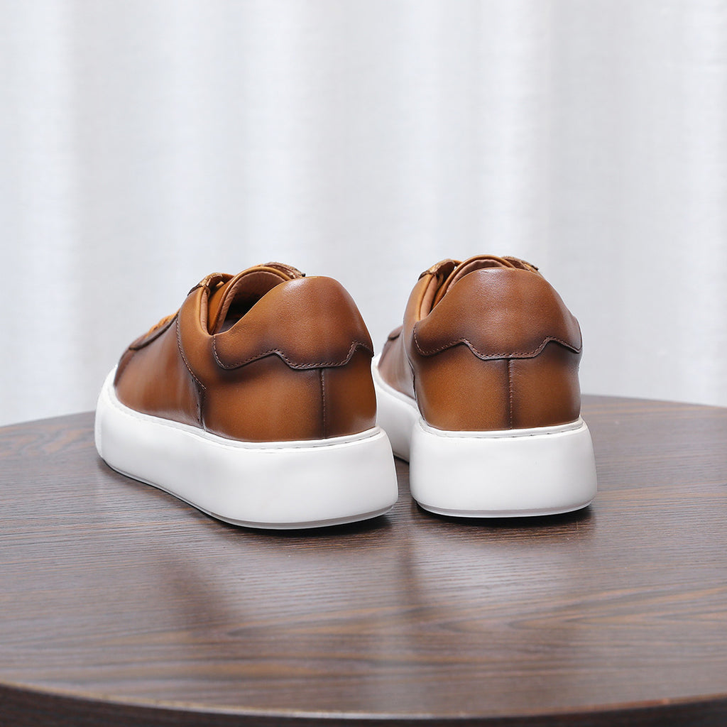 Brown leather sneakers back view with heel cup and white cushioned sole