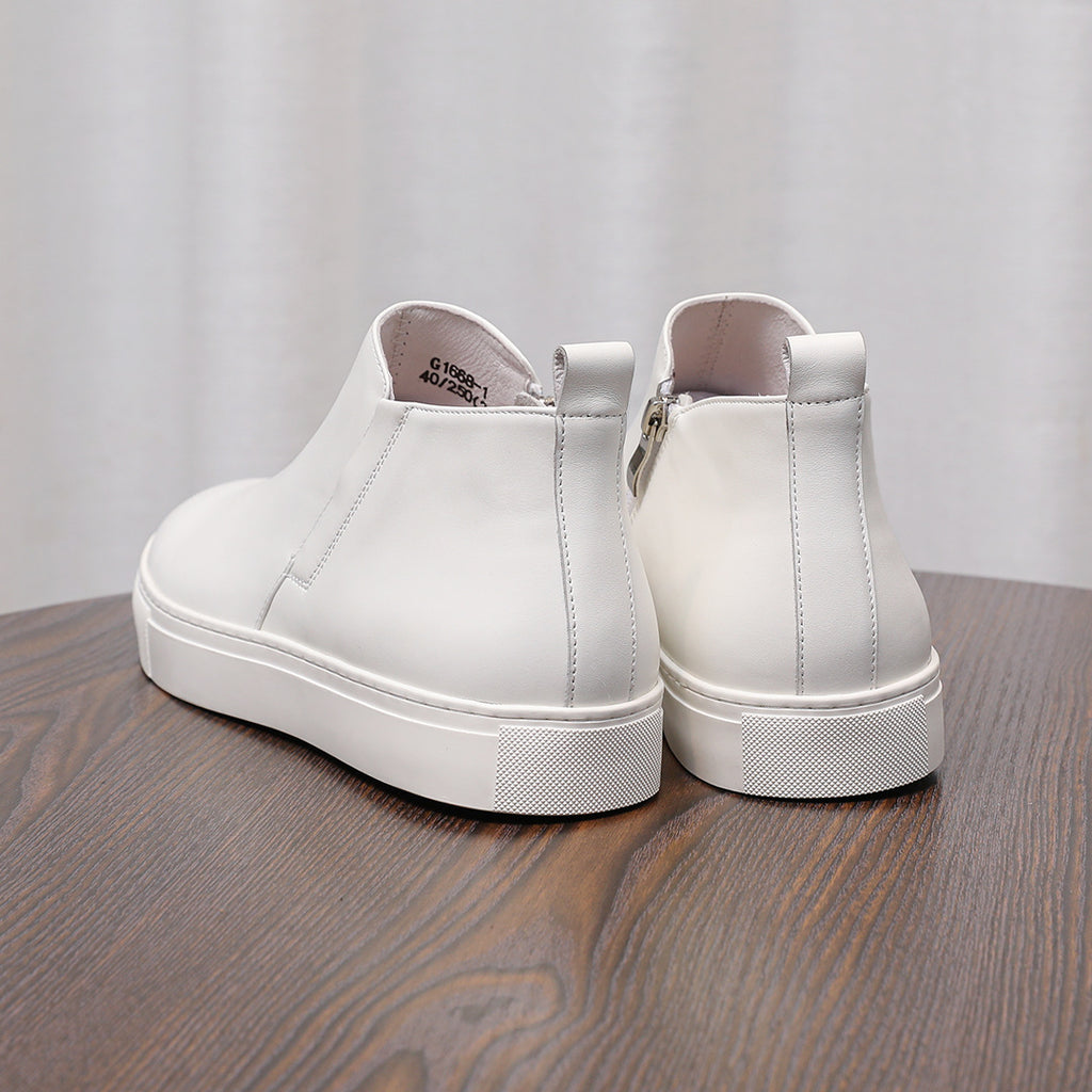 Men's point-toe leather side-zip dress boots, white pair with rubber sole and heel tab