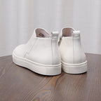 Men's point-toe leather side-zip dress boots, white pair with rubber sole and heel tab