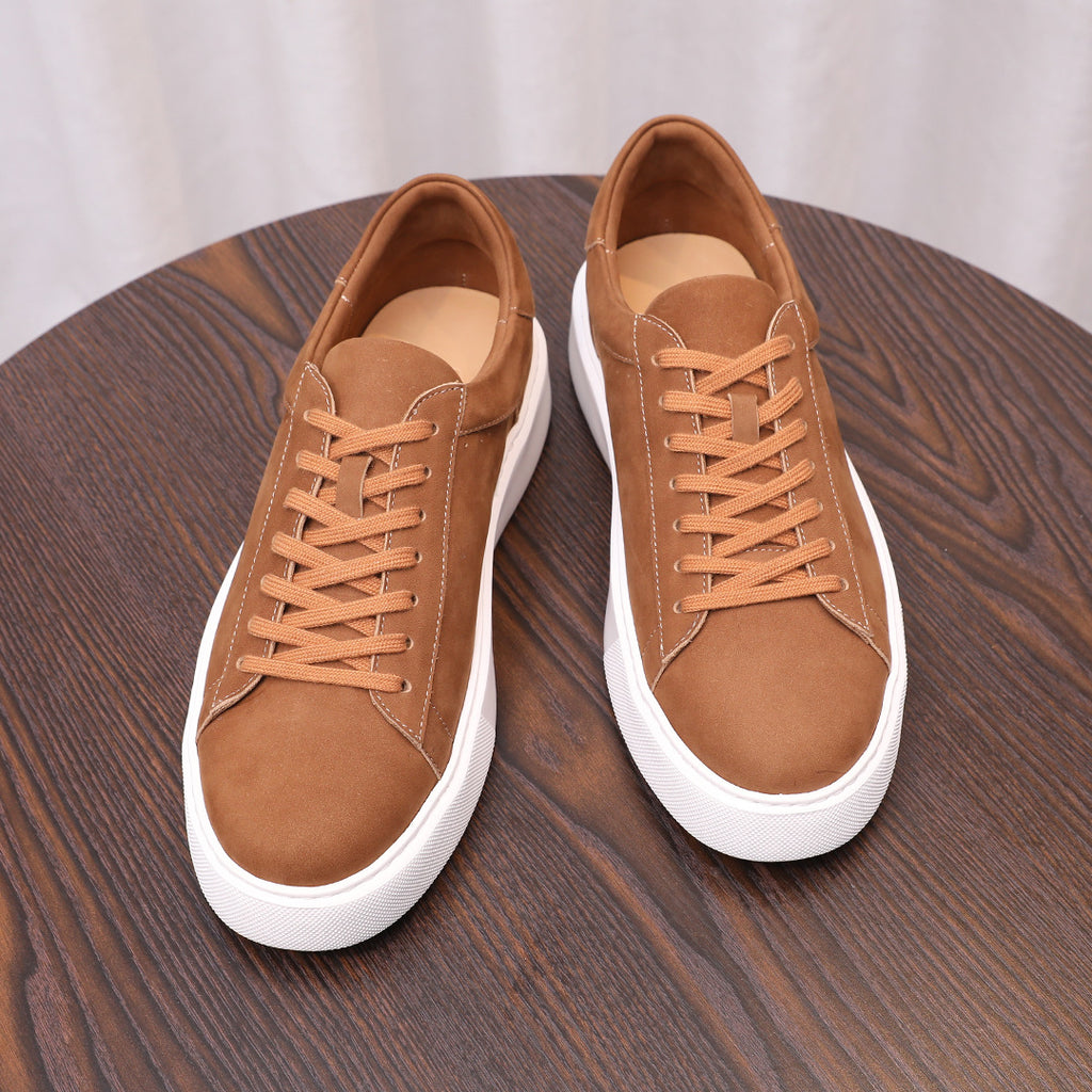 Pair of men's brown suede leather sneakers with lace-up front and white cupsole