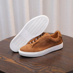 Men's brown suede leather sneakers with textured white outsole, lace-up.