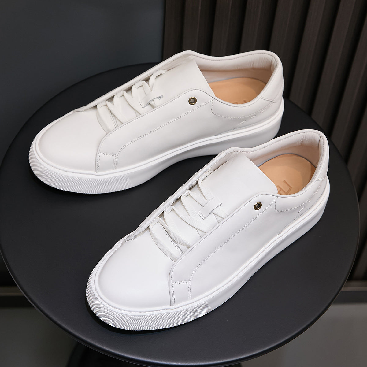 White leather lace-up sneakers with white midsole and clean side stitching