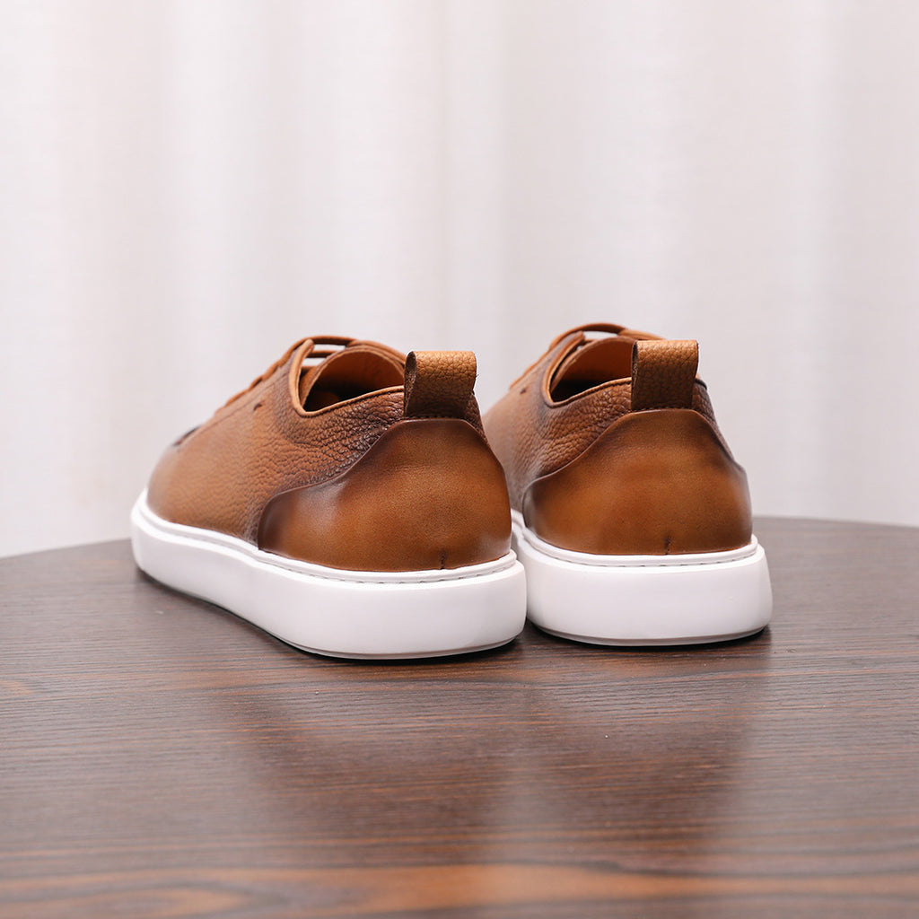 Brown leather low-top sneakers shown from the back, with lace-up and white sole