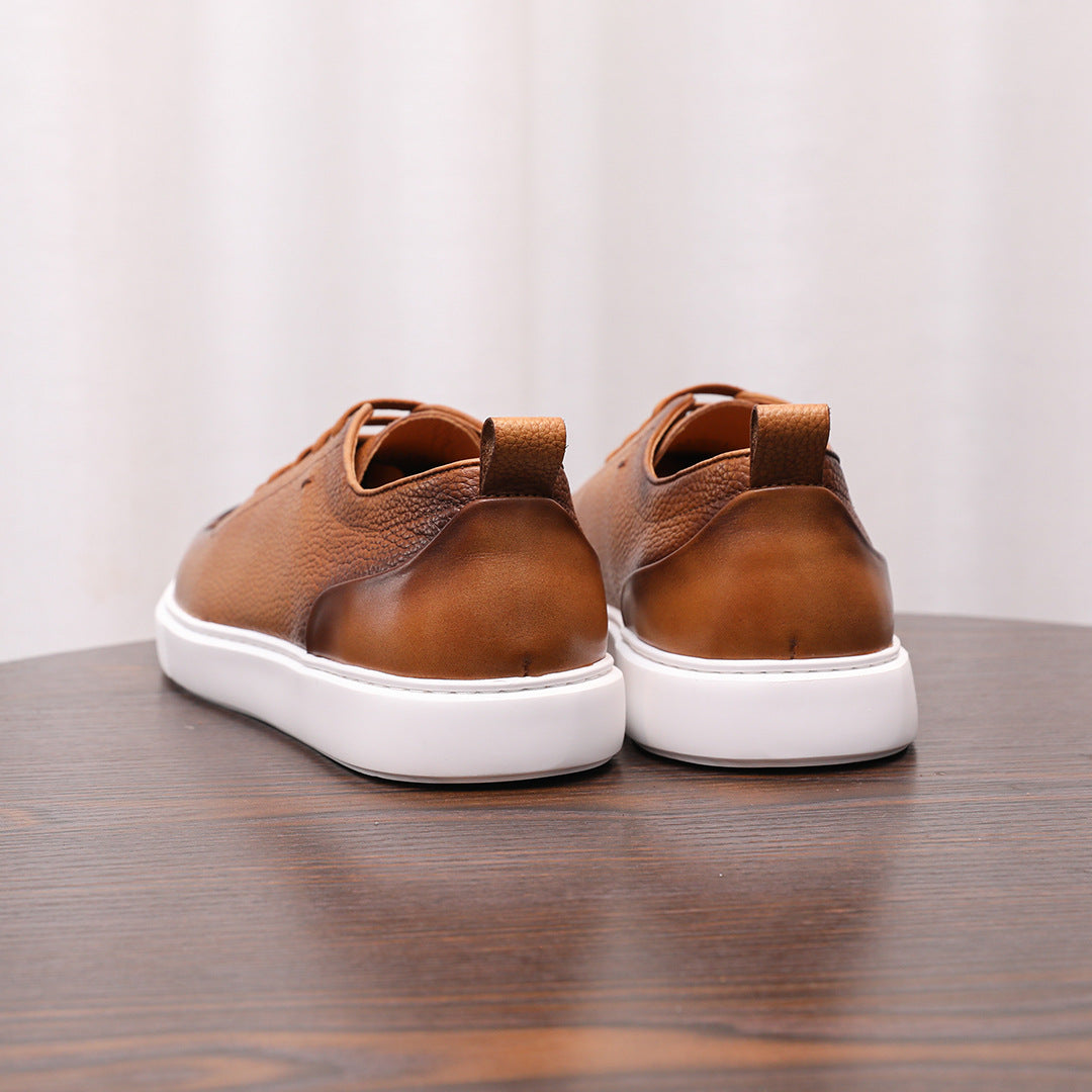 Brown leather low-top sneakers shown from the back, with lace-up and white sole