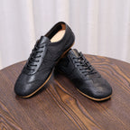 Men's black leather sneakers, pair view with lace-up front and gum rubber outsole