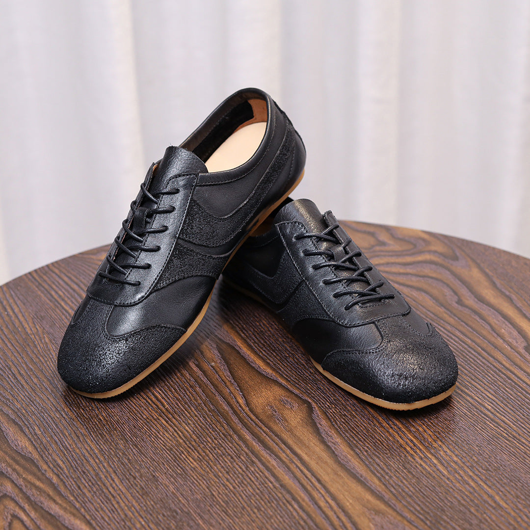 Men's black leather sneakers, pair view with lace-up front and gum rubber outsole