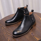 Men's black leather side-zip dress boots with pointed cap toe and low heel