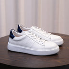 Men's white leather sneakers with lace-up and blue-accent heel, chunky white sole