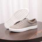 Gray suede leather sneaker with lace-up front and white textured outsole