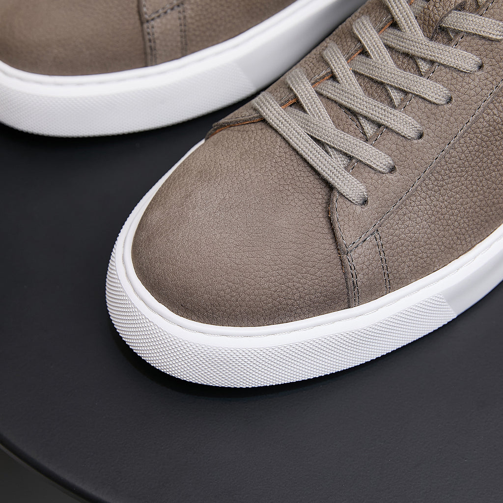 Men's genuine leather sneakers, taupe, close-up of laces, stitched seams, and white sole