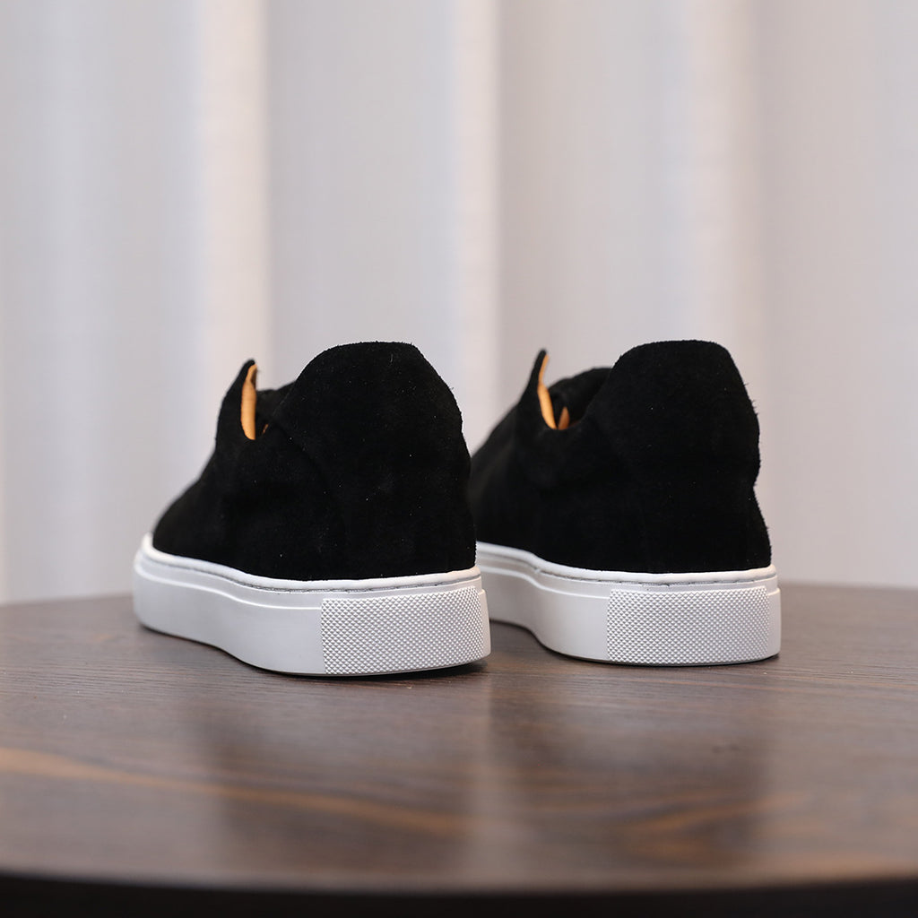 Men's black suede sneakers, heel/back view with lace-up opening and white sole