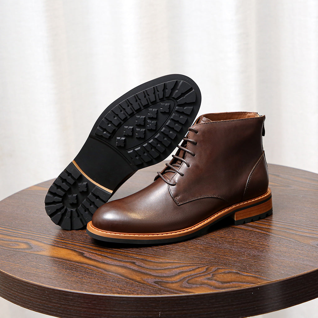 Dark brown leather lace-up ankle boot with pointed toe and visible rubber outsole tread