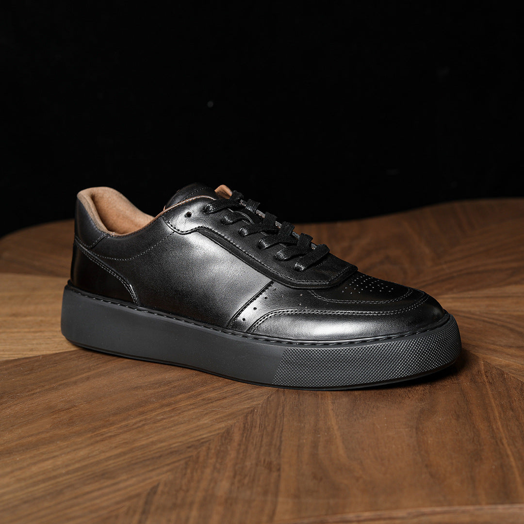 Black leather sneakers with lace-up front and thick textured rubber sole
