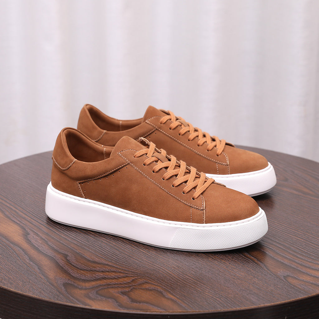 Men's brown leather low-top sneakers with lace-up styling and white rubber sole